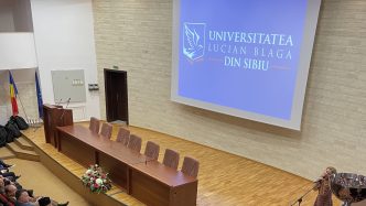 An auditorium filled with professionals at 'Lucian Blaga' University of Sibiu, awaiting a presentation on the benefits of a Master's Program. Because a Master's Program makes the world spin